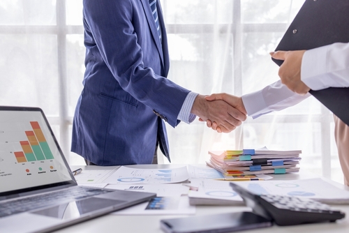 Business man offer and give hand for handshake in office. Successful job interview.